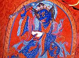 Tibet Guge 06 Tsaparang White Temple 03 01 Mahakala Below Hayagriva�s outstretched right arm is a beautiful painting of blue Mahakala, a wrathful Tantric deity and manifestation of Avalokiteshvara (Tib. Chenrezig). He is blue with fanged teeth and a tiara of skulls, wears richly decorated robes, holds a staff in his right hand and a skull cup brimming with blood in his left. Photo - Weyer/Aschoff: Tsaparang, Tibets Grosses Geheimnis.